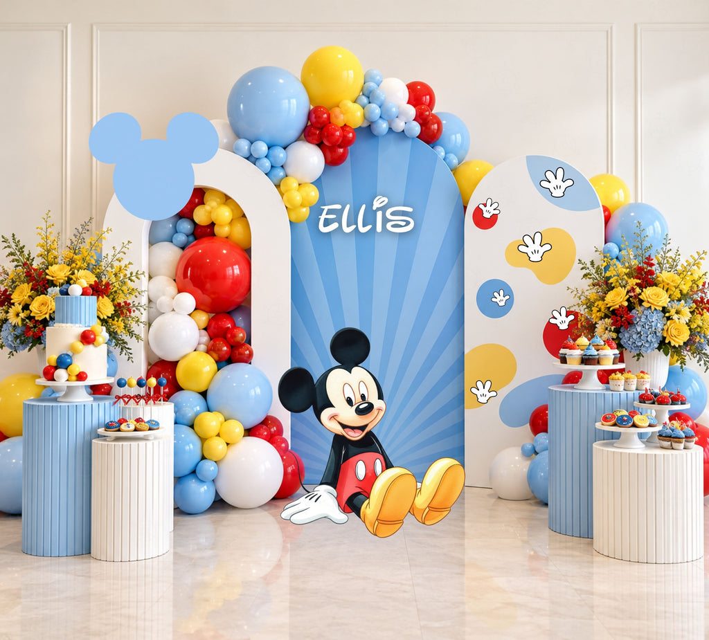 Classic mouse birthday backdrop with light blue arch panels, balloon garland and matching themed decor for a cheerful celebration.