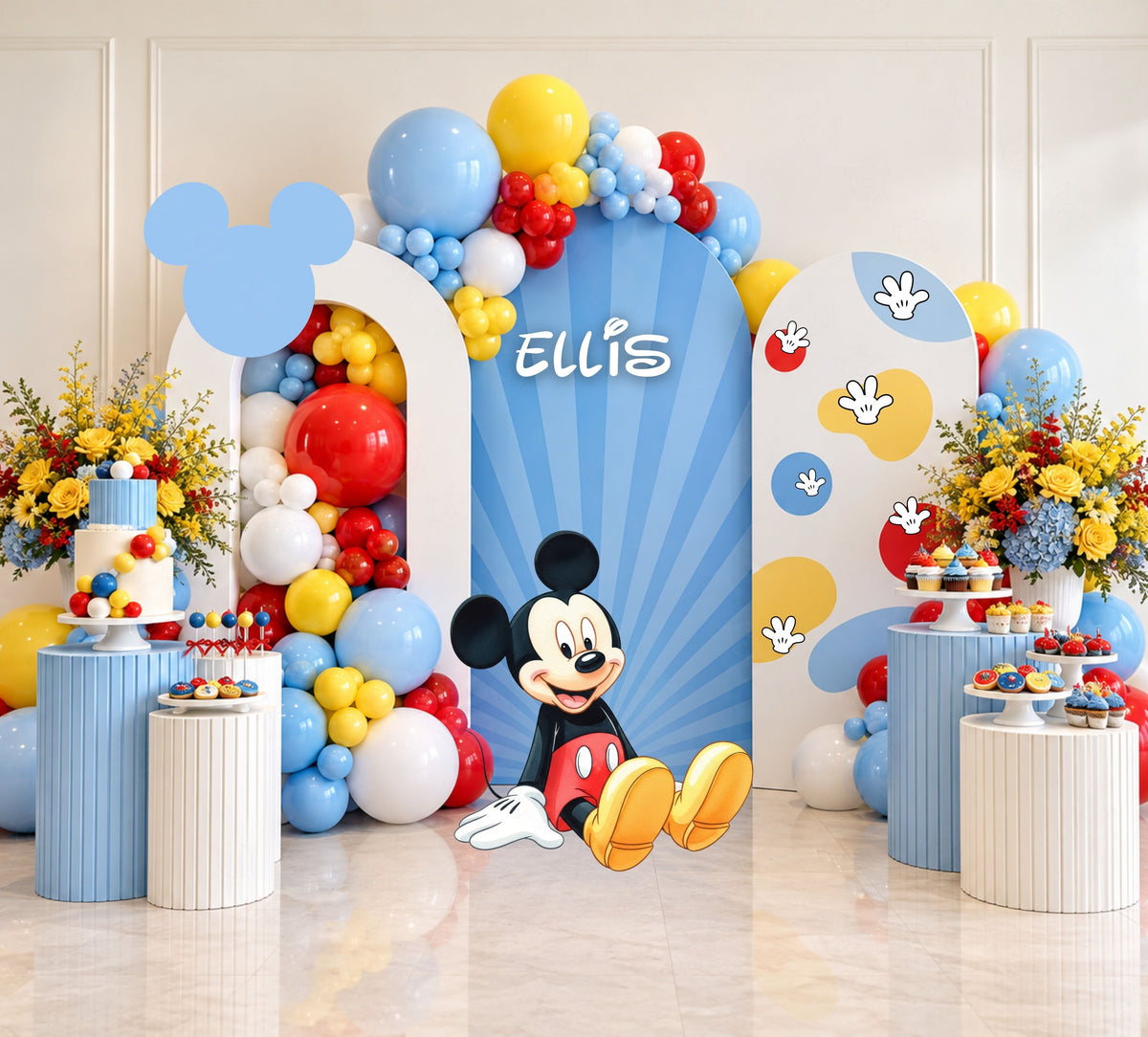 Classic mouse birthday backdrop with light blue arch panels, balloon garland and matching themed decor for a cheerful celebration.
