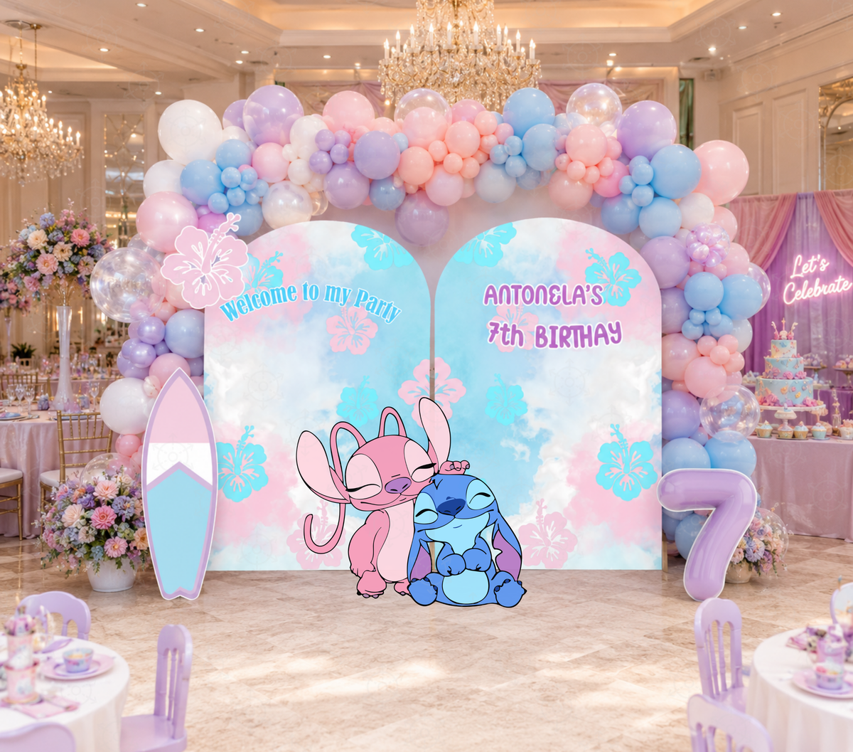 Custom tropical blue alien birthday backdrop set with pastel party panels, coordinated balloon decor and matching character cutouts.