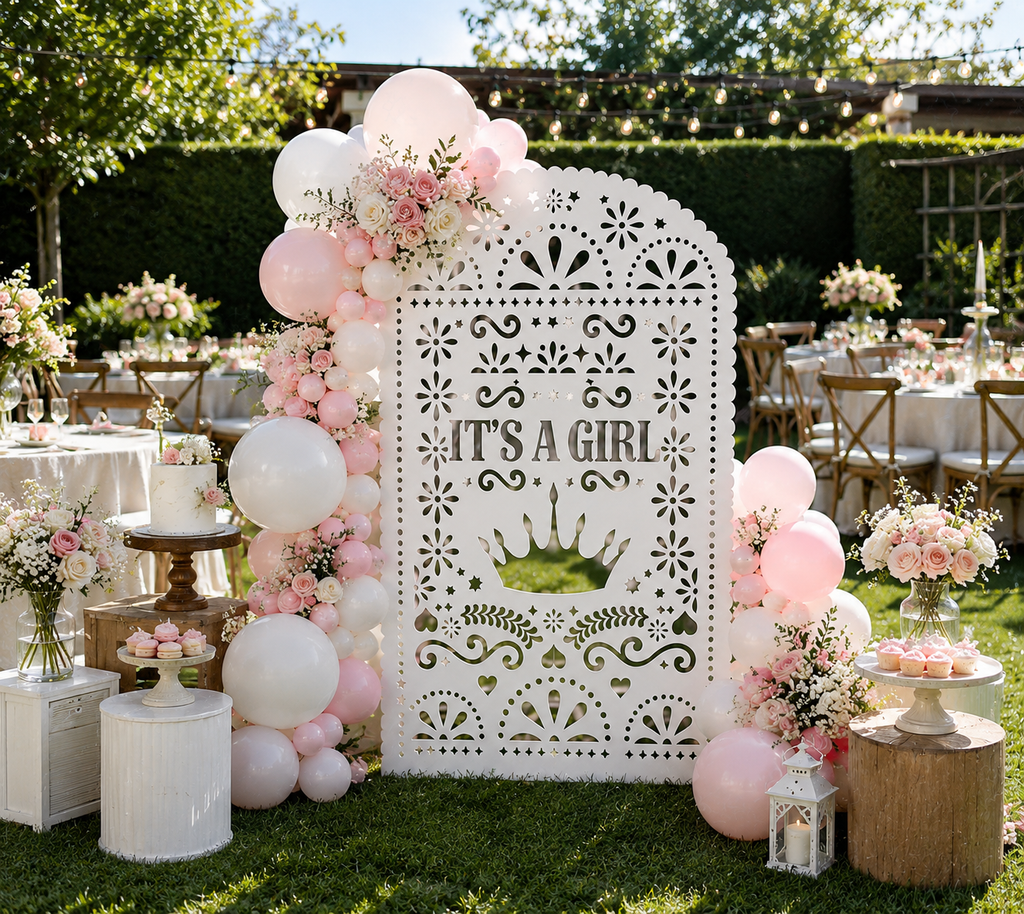 White papel picado baby shower backdrop with pink balloons and elegant outdoor party decor