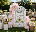 White papel picado baby shower backdrop with pink balloons and elegant outdoor party decor