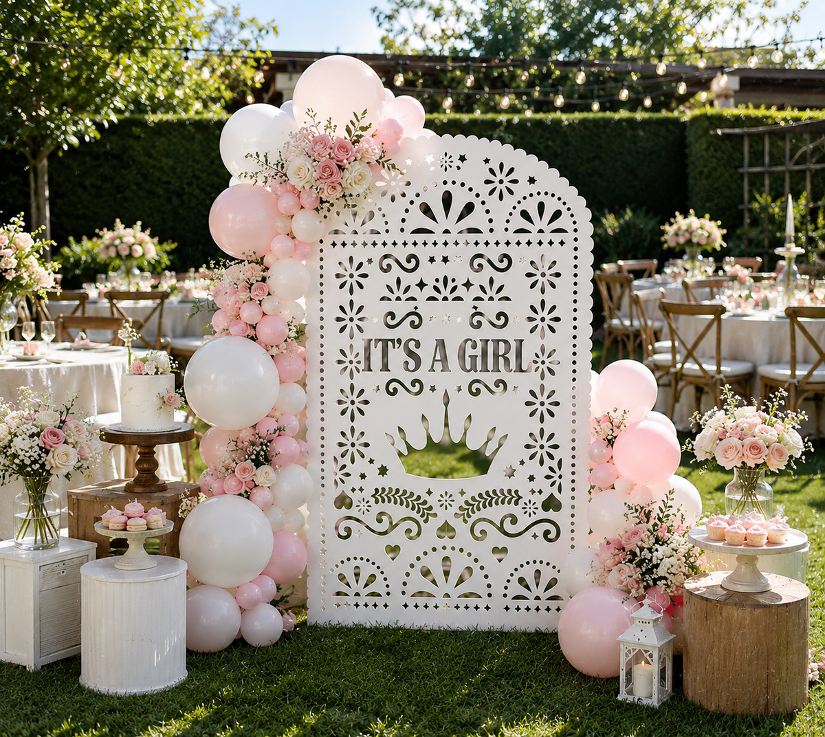 White papel picado baby shower backdrop with pink balloons and elegant outdoor party decor