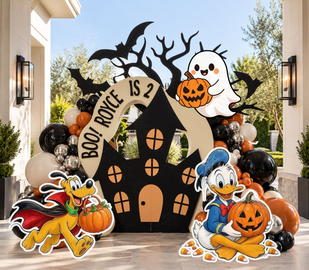 Haunted house spooky birthday backdrop with black orange and neutral balloons, ghost and pumpkin details and matching character cutouts.