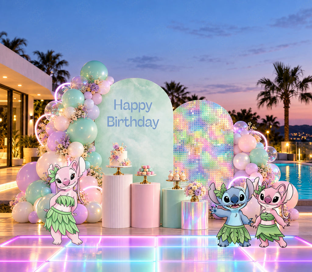 Outdoor pastel alien birthday backdrop with soft pink and aqua arch panels, tropical party details and coordinated character decorations.