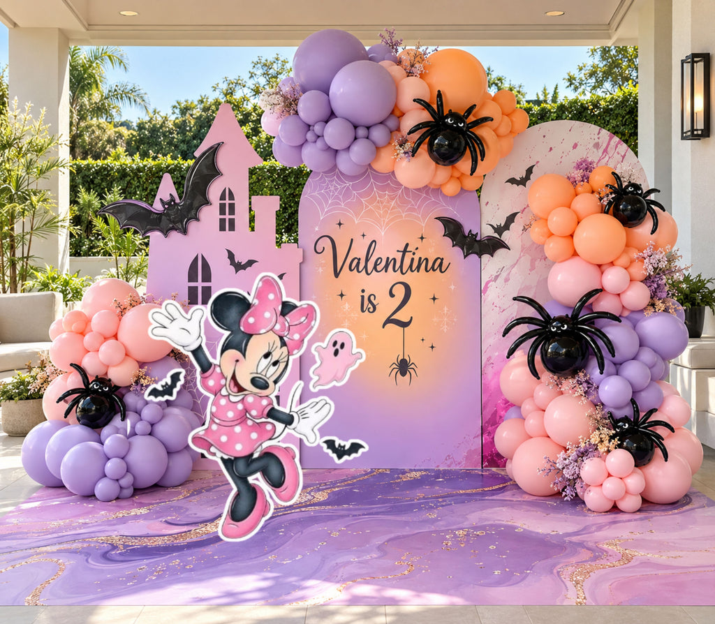 Pink spooky girl birthday backdrop with lavender peach and purple balloons, haunted house details, spider accents and matching character cutout.