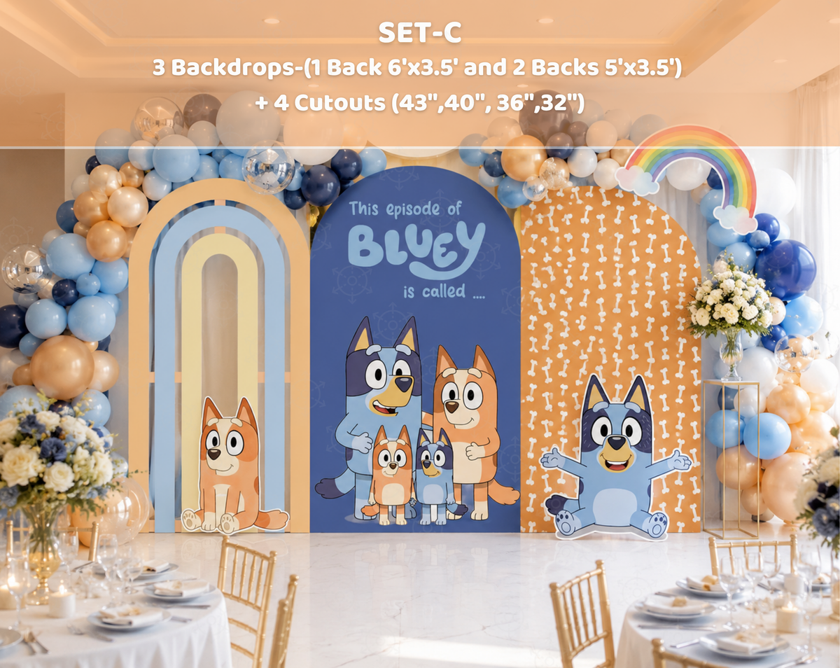 Personalized blue puppy birthday backdrop with warm neutral party decor, balloons and matching character cutouts