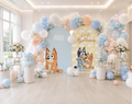 Blue puppy birthday party backdrop with orange balloon accents, personalized panels and matching character decorations